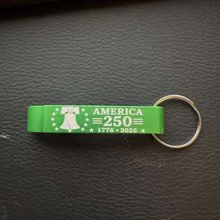Green engraved America 250 keychain with a Liberty Bell design